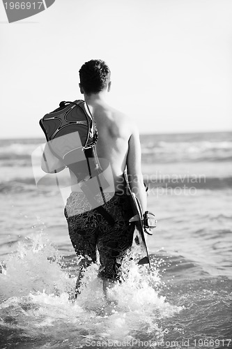 Image of Portrait of a young  kitsurf  man at beach on sunset