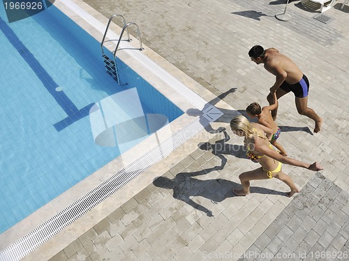 Image of happy young family have fun on swimming pool