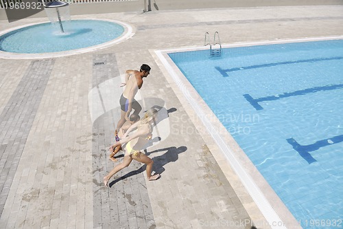 Image of happy young family have fun on swimming pool
