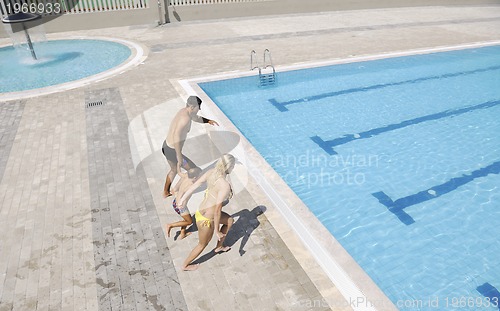 Image of happy young family have fun on swimming pool