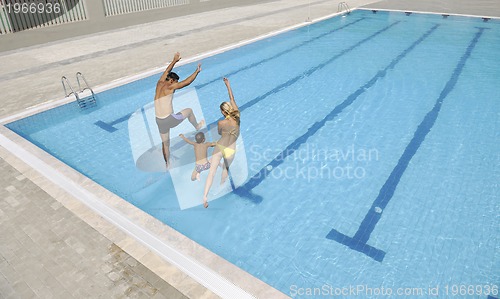 Image of happy young family have fun on swimming pool