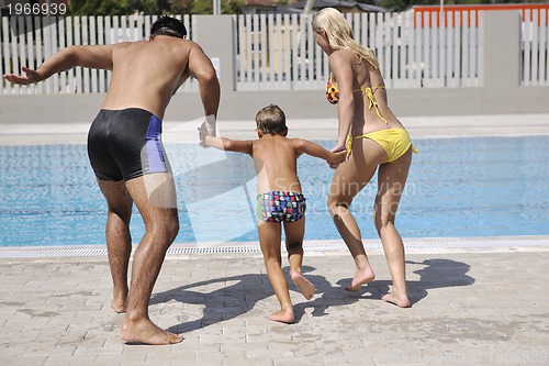 Image of happy young family have fun on swimming pool