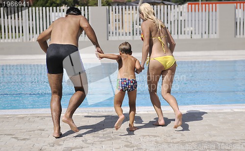 Image of happy young family have fun on swimming pool
