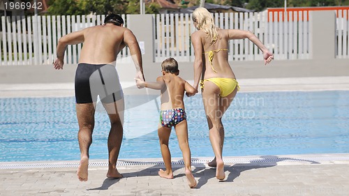 Image of happy young family have fun on swimming pool 