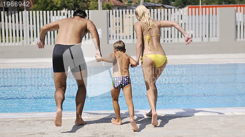Image of happy young family have fun on swimming pool 