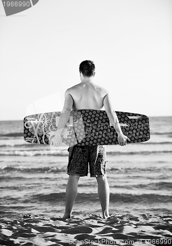 Image of Portrait of a young  kitsurf  man at beach on sunset