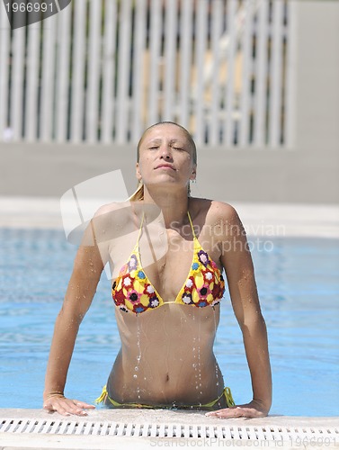 Image of beautiful woman relax on swimming pool