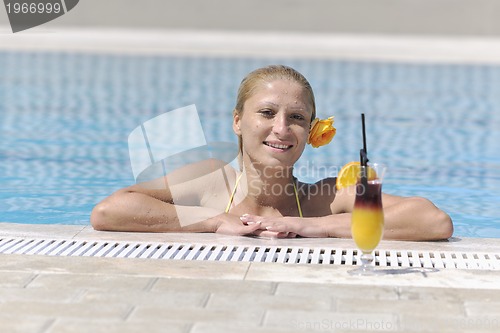 Image of beautiful woman relax on swimming pool