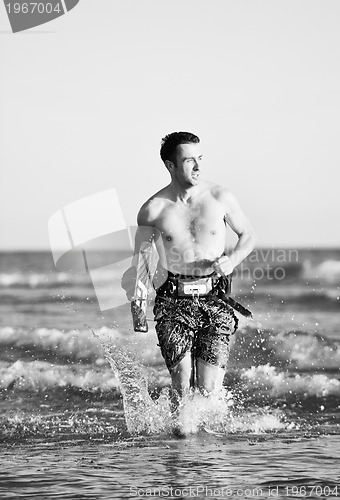 Image of Portrait of a young  kitsurf  man at beach on sunset