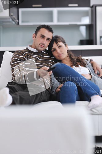 Image of Relaxed young  couple watching tv at home