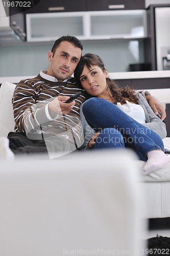 Image of Relaxed young  couple watching tv at home