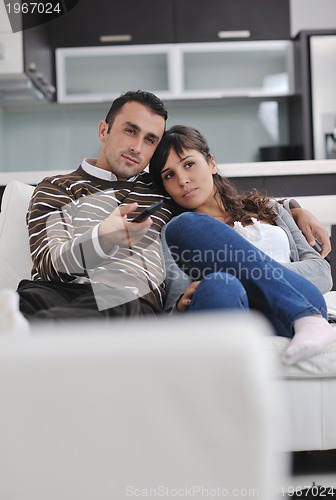 Image of Relaxed young  couple watching tv at home