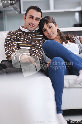 Image of Relaxed young  couple watching tv at home