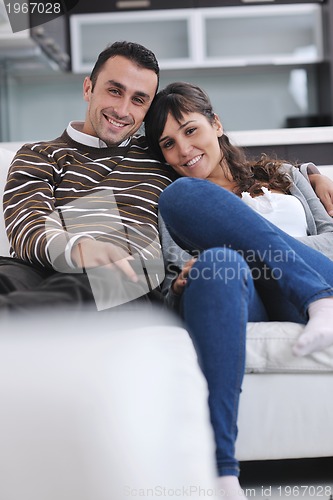 Image of Relaxed young  couple watching tv at home