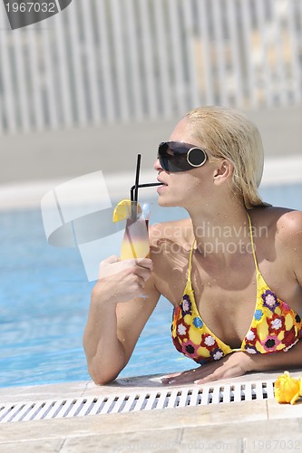 Image of beautiful woman relax on swimming pool