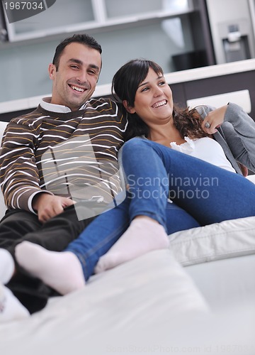 Image of Relaxed young  couple watching tv at home