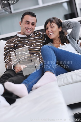 Image of Relaxed young  couple watching tv at home