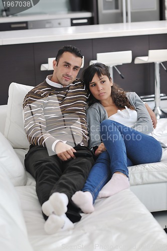 Image of Relaxed young  couple watching tv at home