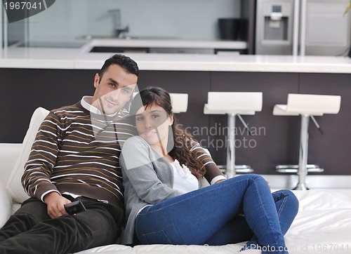 Image of Relaxed young  couple watching tv at home