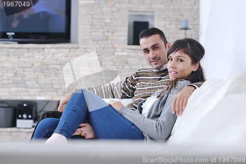 Image of Relaxed young  couple watching tv at home