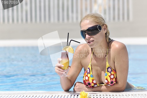 Image of beautiful woman relax on swimming pool