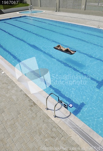 Image of woman relax on swimming pool