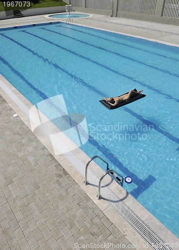 Image of beautiful woman relax on swimming pool