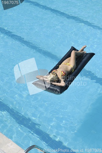 Image of beautiful woman relax on swimming pool