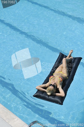 Image of beautiful woman relax on swimming pool