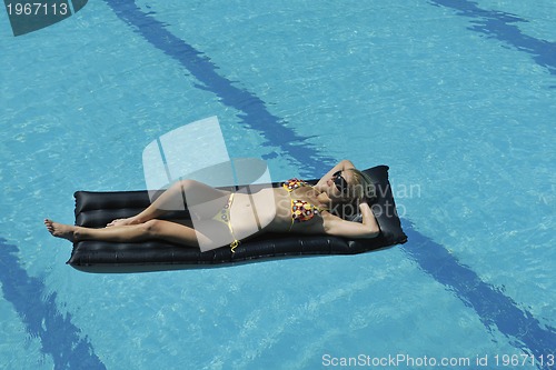 Image of beautiful woman relax on swimming pool