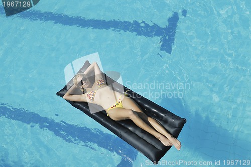 Image of woman relax on swimming pool