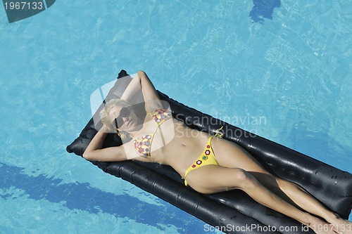 Image of woman relax on swimming pool