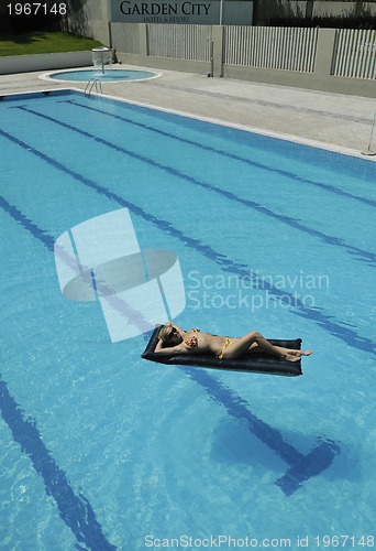 Image of beautiful woman relax on swimming pool