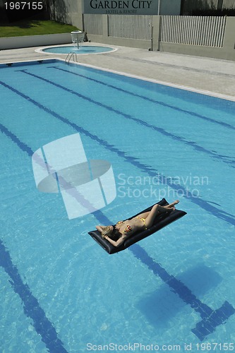 Image of beautiful woman relax on swimming pool