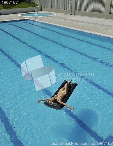 Image of beautiful woman relax on swimming pool