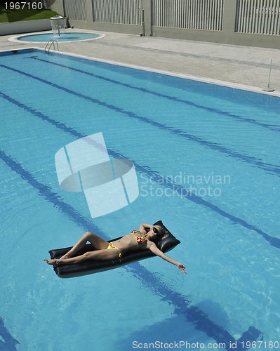 Image of beautiful woman relax on swimming pool