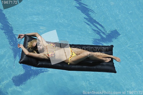 Image of beautiful woman relax on swimming pool