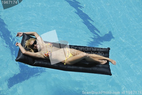 Image of woman relax on swimming pool