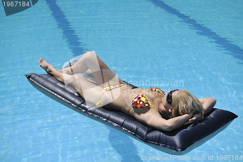 Image of beautiful woman relax on swimming pool