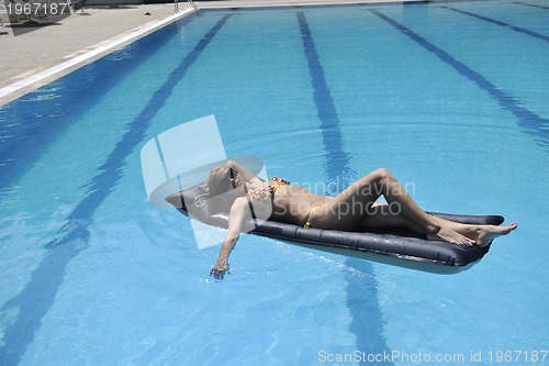 Image of beautiful woman relax on swimming pool