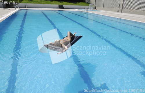 Image of woman relax on swimming pool