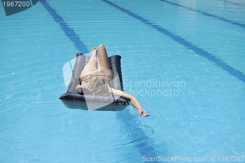 Image of woman relax on swimming pool