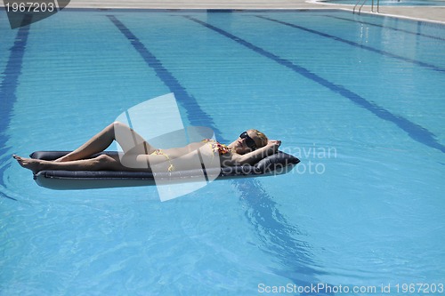 Image of woman relax on swimming pool