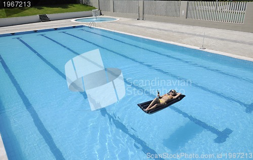 Image of beautiful woman relax on swimming pool