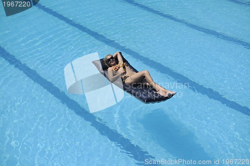 Image of beautiful woman relax on swimming pool