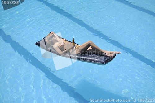 Image of beautiful woman relax on swimming pool