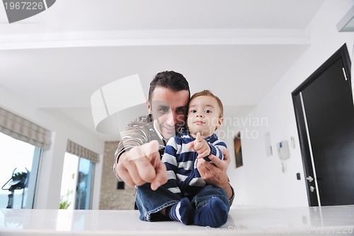 Image of happy father and son together at home