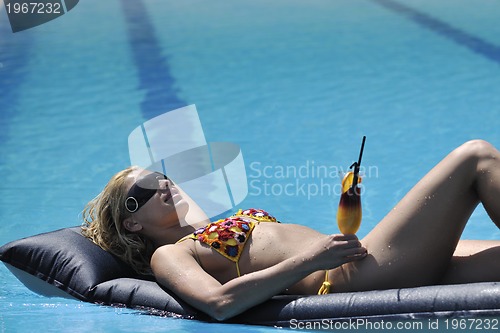 Image of woman relax on swimming pool