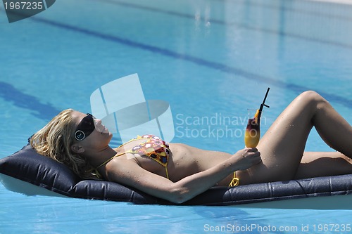 Image of beautiful woman relax on swimming pool