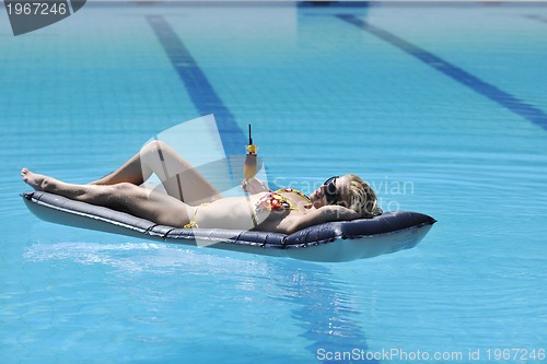 Image of woman relax on swimming pool
